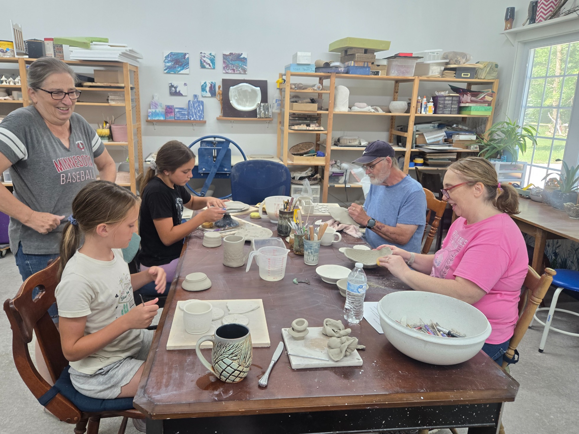 Youth and adults learning ceramics