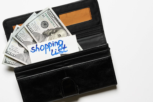 Wallet with money and shopping list