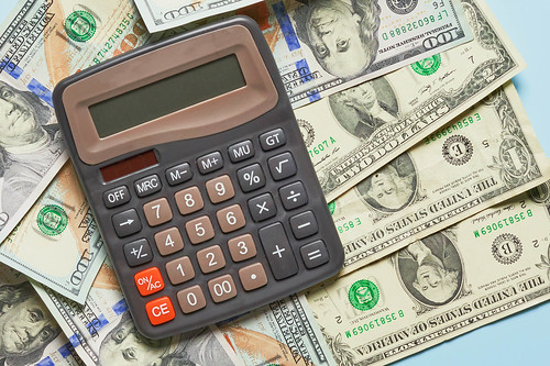Business concept - calculator on money background