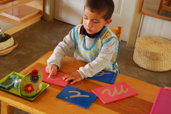 3 year-old tracing sandpaper letters