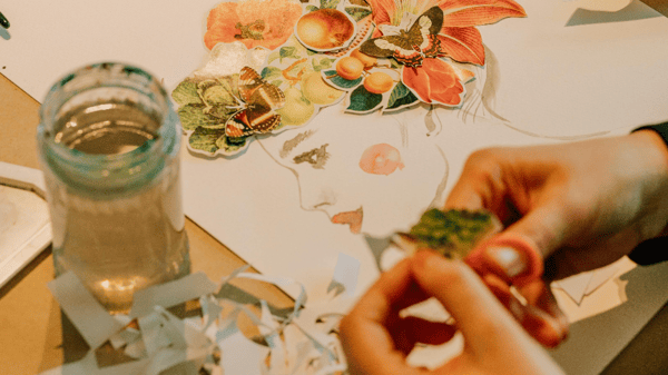 Close-up of a collage of a woman's face, made with paper. 