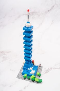 Creative Lego tower model on a marble surface with bright colors and intricate design details.