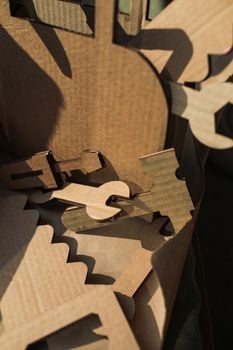 Close-up of cardboard cutouts with intricate designs casting shadows.