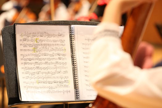 Detailed view of musical notes on sheet music during an orchestra rehearsal.
