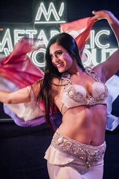 Vibrant belly dancer in Mexico City exuding joy with colorful fabrics and radiant smile.