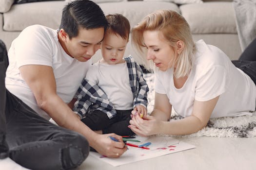 Loving family creating art together, fostering play and connection indoors.
