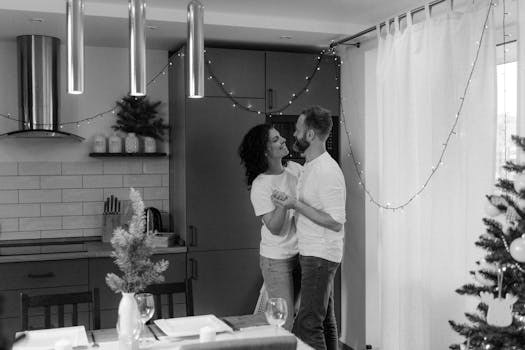 A happy couple dancing in their decorated home during the festive season