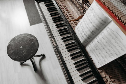 Top view of piano keys and sheet music, capturing a classic musical ambiance.