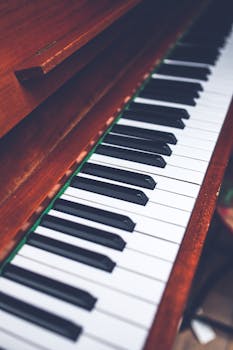 Close-up view of a wooden piano keyboard with black and white keys, showcasing classic design.