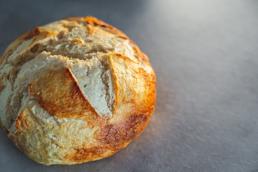 Golden crusted artisan bread freshly baked, showcasing detailed textures and color.