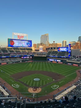 A vibrant evening view of Target Field hosting a baseball game in summer.