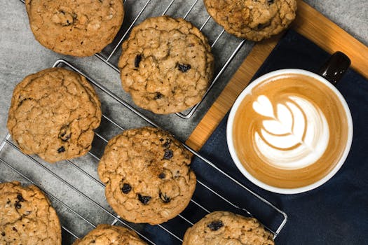 Indulge in homemade oatmeal cookies paired perfectly with a latte featuring beautiful latte art.