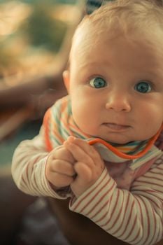Close-up portrait of an adorable baby with captivating blue eyes, showcasing innocence and curiosity.