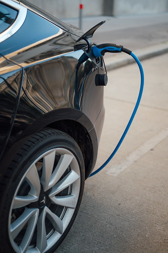 Electric vehicle plugged in a public charging station