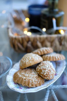 Tasty sesame cookies on a floral-patterned plate, perfect for dessert or snack occasions.