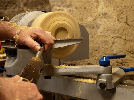 Skilled artisan crafting a wooden bowl using a lathe in a rustic workshop setting.